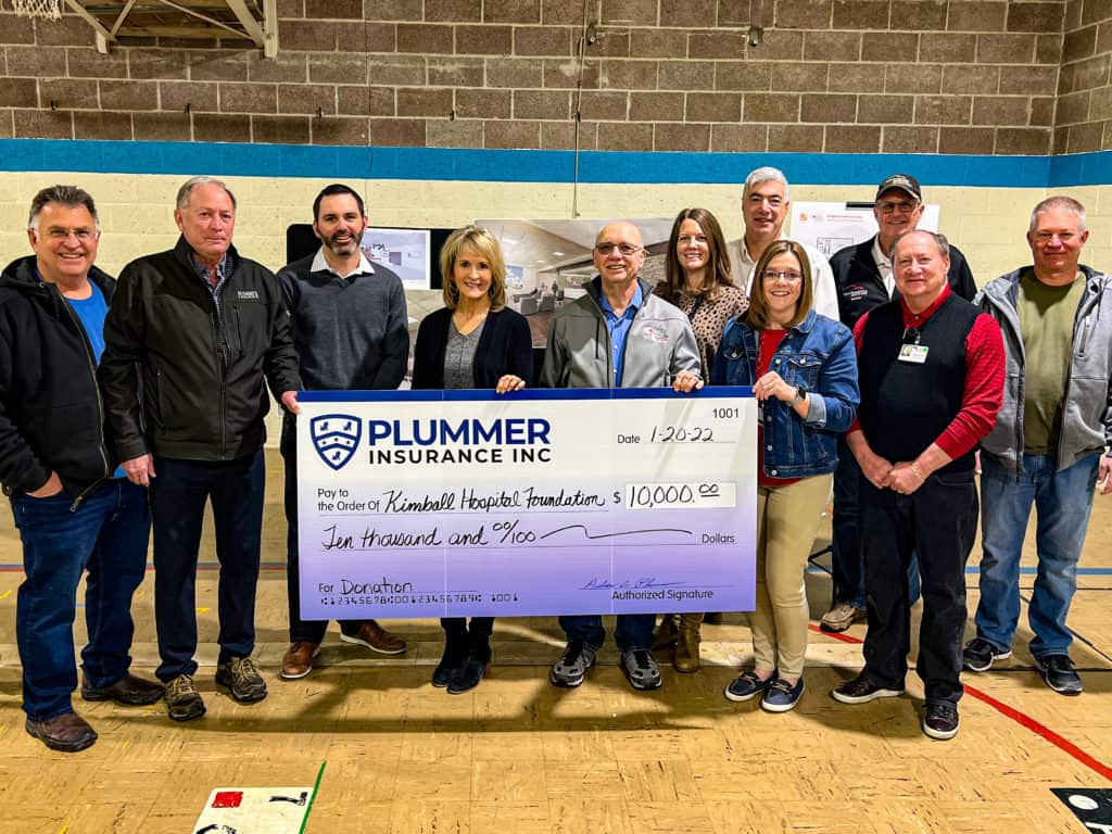 Plummer Insurance Employees Making a Donation to the Hospital Foundation in Kimball, Nebraska as part of their charity and philanthropy.