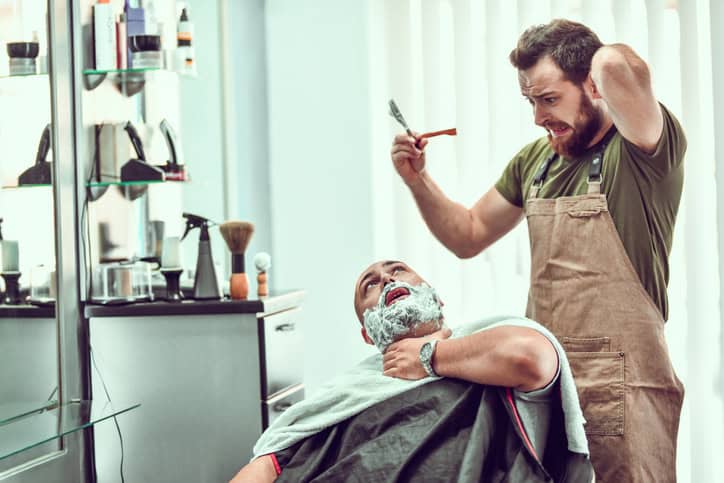 man pretends to be injured by a barber while shaving